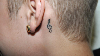 Illustration for article titled Justin Bieber's Tattoos Documented by the Miami PD: A Visual Analysis